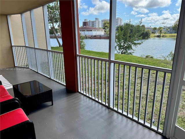 unfurnished sunroom featuring a water view