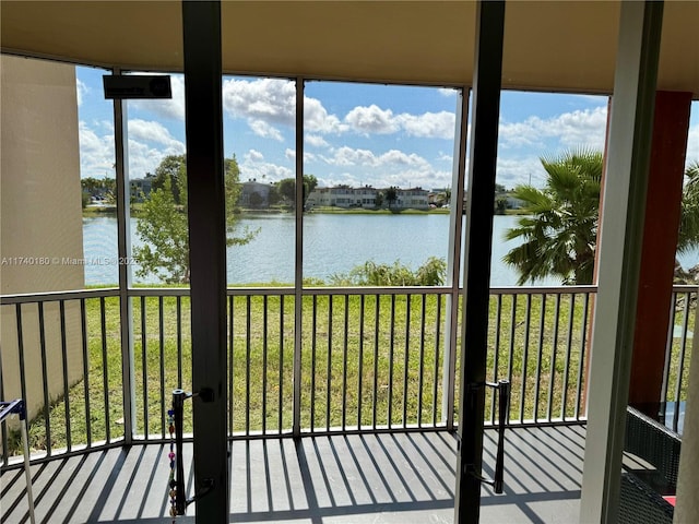 unfurnished sunroom with a water view