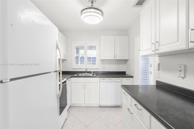 kitchen featuring white cabinetry, sink, light tile patterned flooring, and white appliances