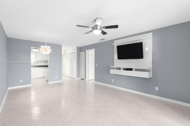 unfurnished living room with light tile patterned floors and ceiling fan with notable chandelier