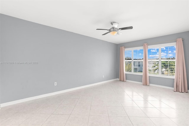 tiled empty room featuring ceiling fan