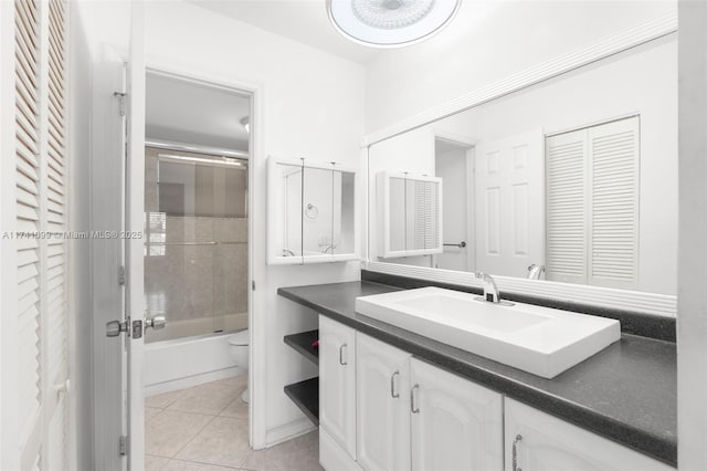 full bathroom with vanity, combined bath / shower with glass door, tile patterned floors, and toilet