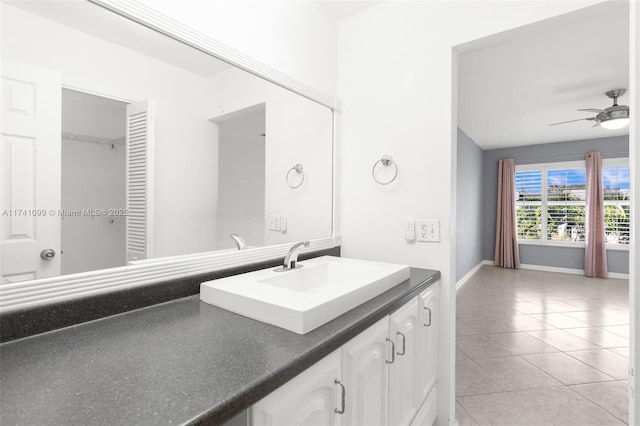 bathroom with tile patterned flooring, vanity, and ceiling fan