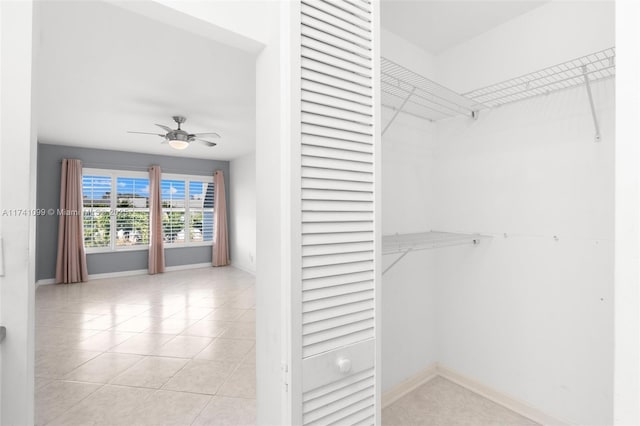 walk in closet with ceiling fan and light tile patterned floors