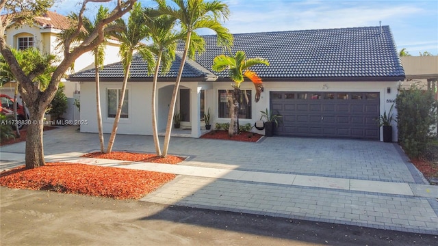 mediterranean / spanish home featuring a garage