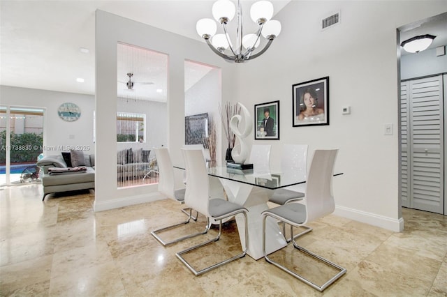 dining area featuring ceiling fan with notable chandelier