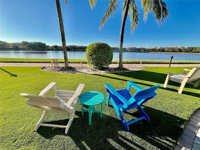 exterior space featuring a lawn and a water view