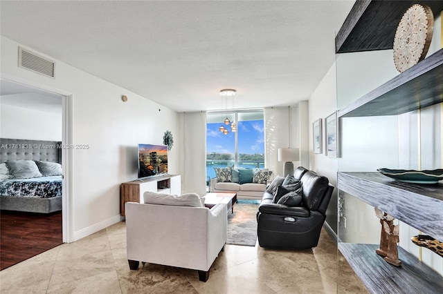 2681 N Flamingo Rd Unit 605S, Sunrise, FL 33323 - living room featuring a wall of windows, a chandelier, baseboards, and light tile patterned floors