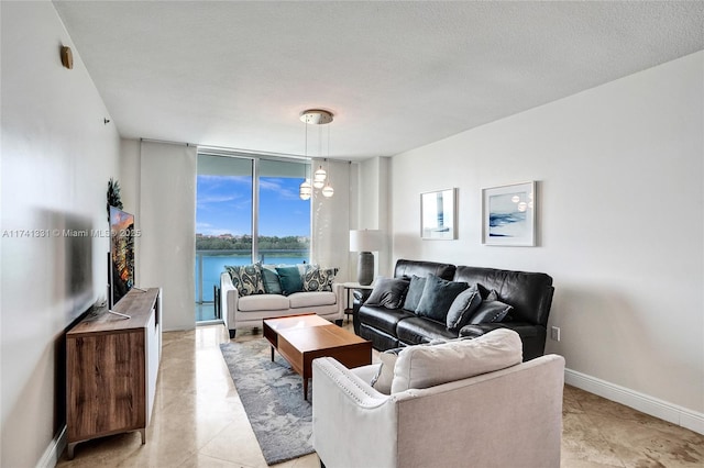 2681 N Flamingo Rd Unit 605S, Sunrise, FL 33323 - living area with a wall of windows, a chandelier, baseboards, and light tile patterned flooring