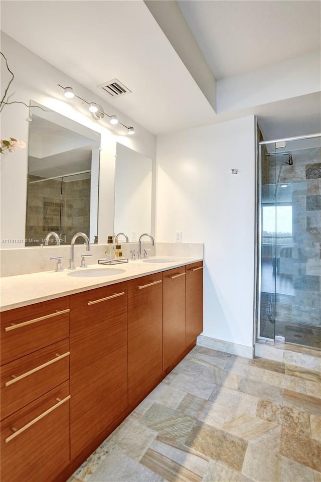 2681 N Flamingo Rd Unit 605S, Sunrise, FL 33323 - full bathroom featuring double vanity, a stall shower, and baseboards