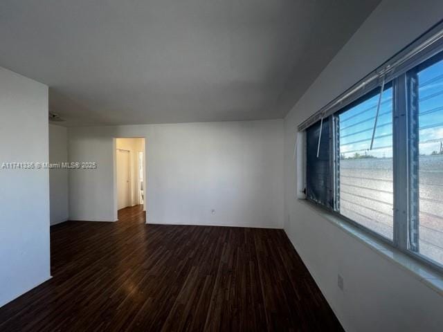 spare room featuring dark wood-type flooring