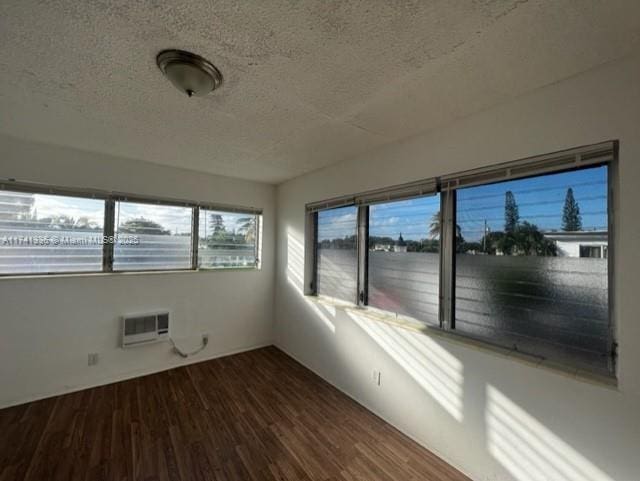 unfurnished sunroom with a wall mounted AC