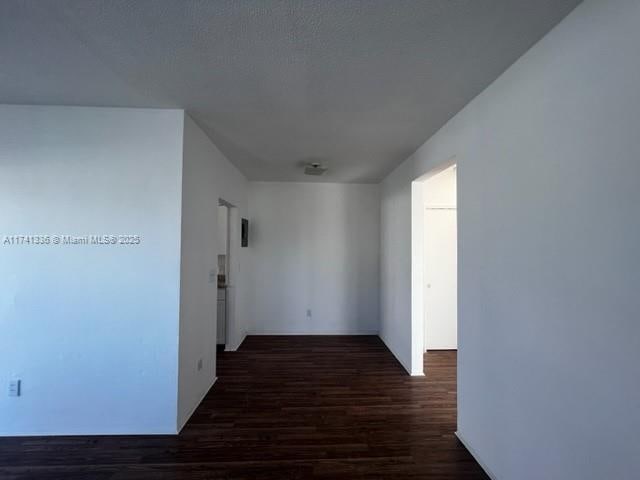 corridor with dark wood-type flooring