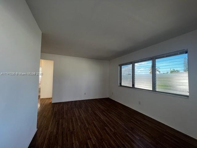 empty room with dark hardwood / wood-style floors