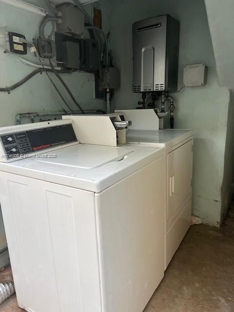 washroom featuring water heater and washer and dryer