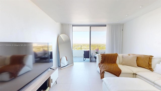 600 N Three Islands Blvd Unit 803, Hallandale Beach, FL 33009 - living area with light tile patterned floors and a wall of windows