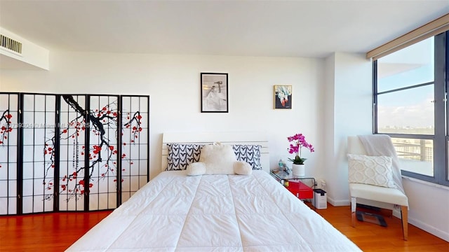 600 N Three Islands Blvd Unit 803, Hallandale Beach, FL 33009 - bedroom featuring baseboards, visible vents, and wood finished floors
