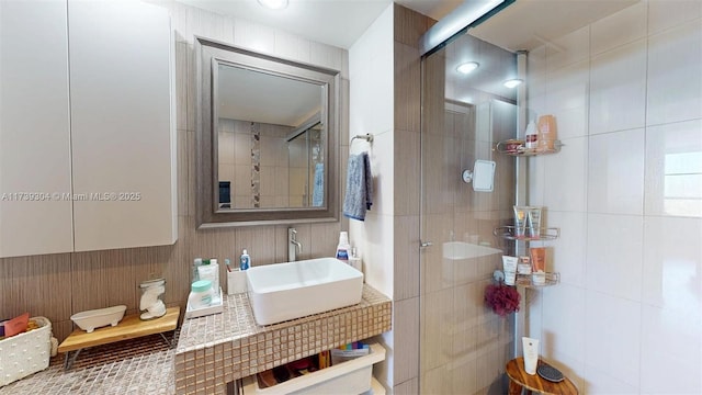 600 N Three Islands Blvd Unit 803, Hallandale Beach, FL 33009 - full bathroom featuring tile walls, tiled shower, and a sink