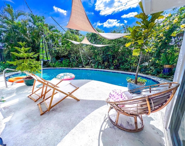 outdoor pool with a patio area