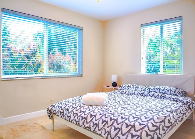 bedroom with multiple windows and baseboards