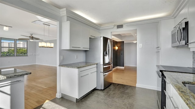 2801 NE 183rd St Unit 517W, Aventura, FL 33160 - kitchen with appliances with stainless steel finishes, ceiling fan, baseboards, light stone countertops, and ornamental molding