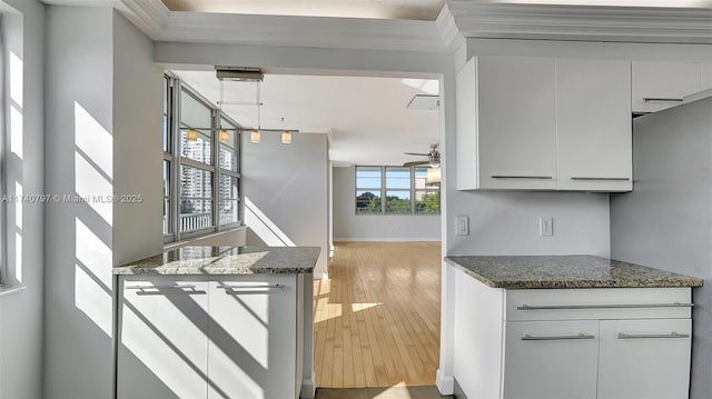 2801 NE 183rd St Unit 517W, Aventura, FL 33160 - kitchen with light wood-type flooring, white cabinets, a ceiling fan, and dark stone counters