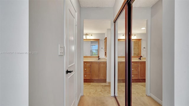 2801 NE 183rd St Unit 517W, Aventura, FL 33160 - hallway featuring a sink and baseboards