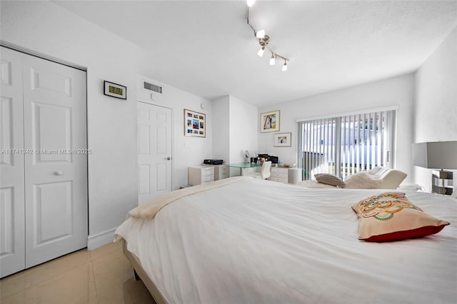 tiled bedroom featuring a closet