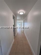 hallway with dark tile patterned flooring