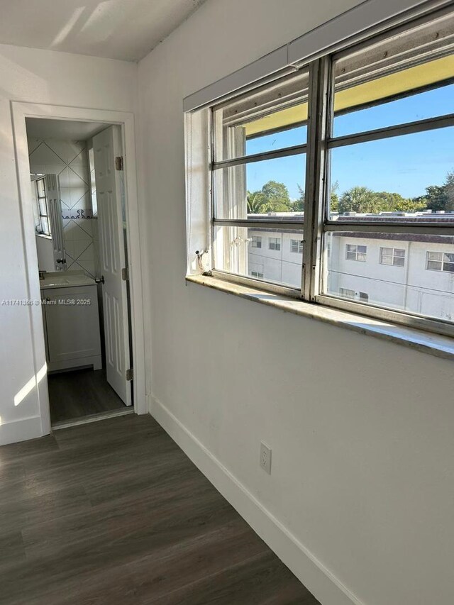 corridor with dark hardwood / wood-style flooring