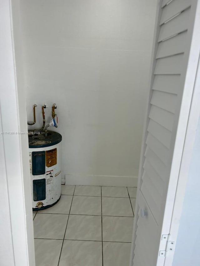 bathroom featuring tile patterned flooring and water heater