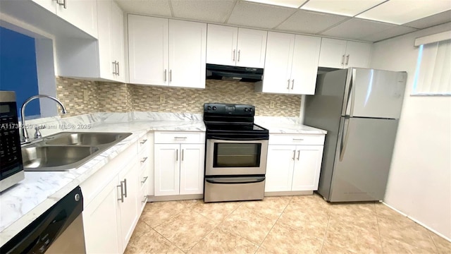 kitchen featuring sink, a drop ceiling, white cabinets, stainless steel appliances, and backsplash