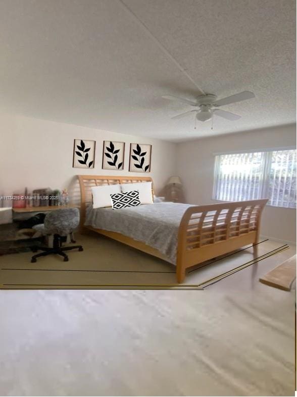 bedroom with ceiling fan and a textured ceiling