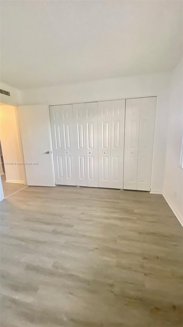 unfurnished bedroom featuring wood-type flooring