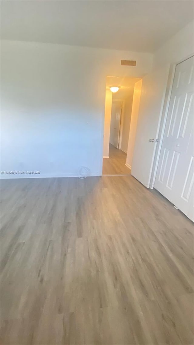 empty room with light hardwood / wood-style floors