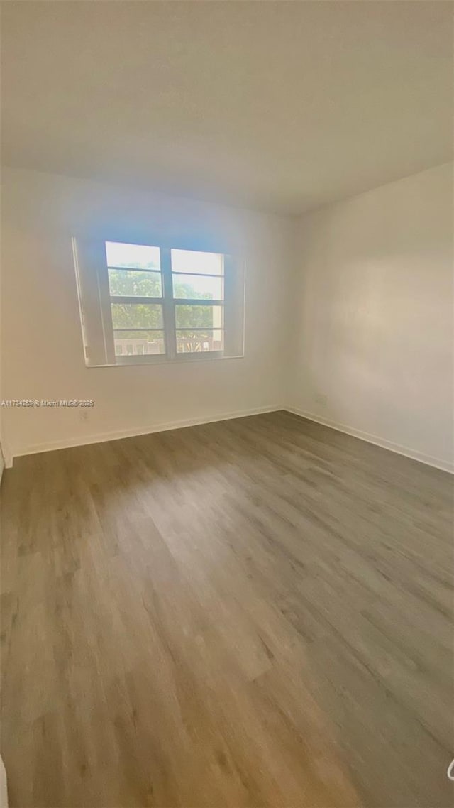 unfurnished room featuring hardwood / wood-style floors