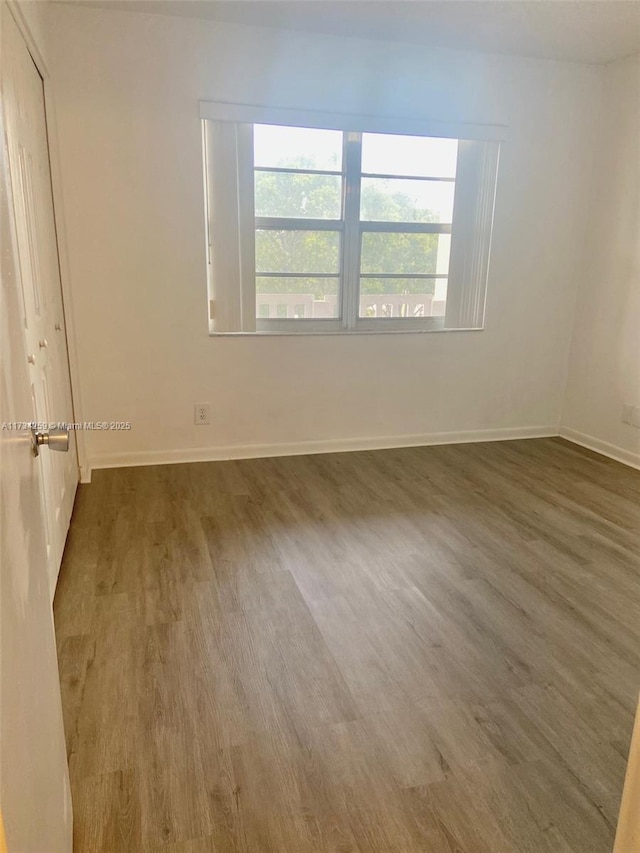 unfurnished room featuring dark wood-type flooring