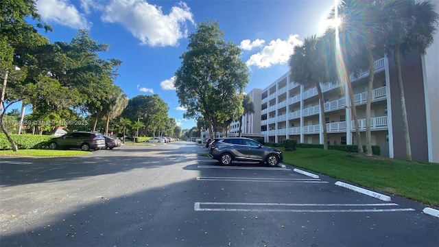 view of parking with a yard
