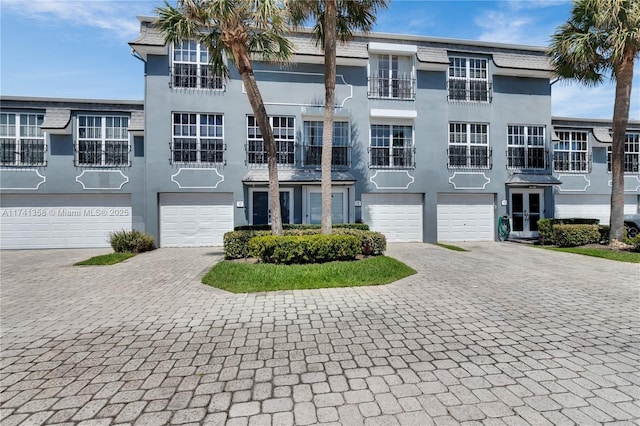 1194 Hillsboro Mile Unit 72, Hillsboro Beach, FL 33062 - townhome / multi-family property with driveway, an attached garage, and stucco siding