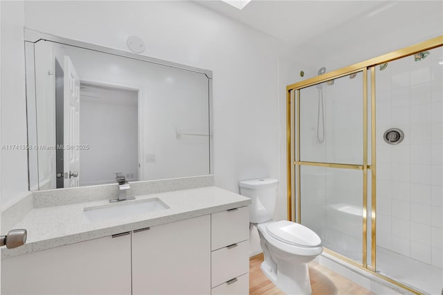 1194 Hillsboro Mile Unit 72, Hillsboro Beach, FL 33062 - full bathroom featuring a stall shower, toilet, vanity, and wood finished floors