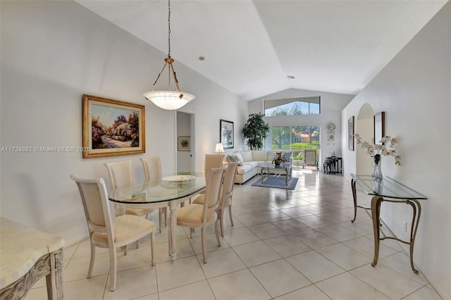 tiled dining room with high vaulted ceiling