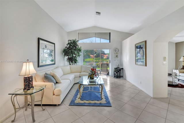 living room featuring lofted ceiling and light tile patterned floors