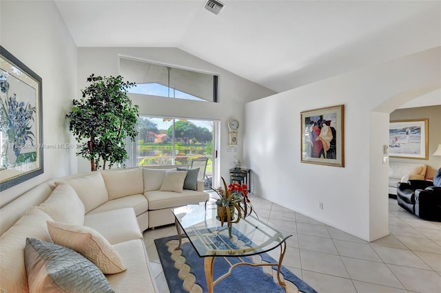 living room featuring vaulted ceiling and light tile patterned floors