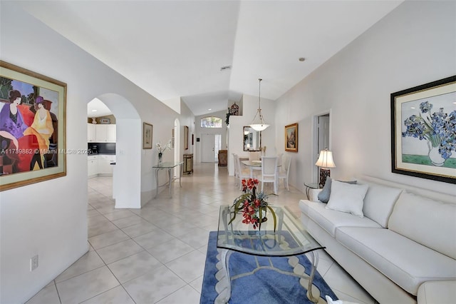 living room featuring lofted ceiling and light tile patterned floors