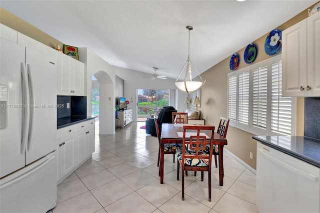 tiled dining space with ceiling fan