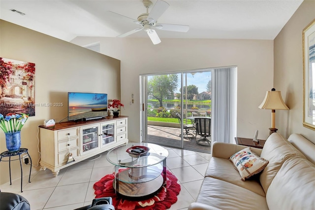 living room featuring light tile patterned floors, vaulted ceiling, and ceiling fan