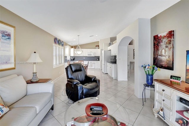 living room with lofted ceiling and light tile patterned floors