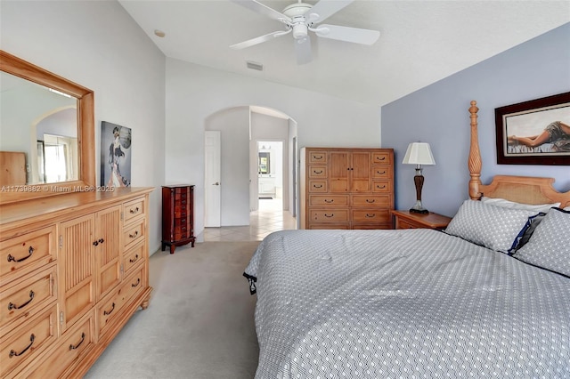 carpeted bedroom featuring multiple windows, lofted ceiling, and ceiling fan