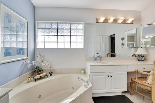 bathroom featuring tile patterned floors, a tub to relax in, and vanity