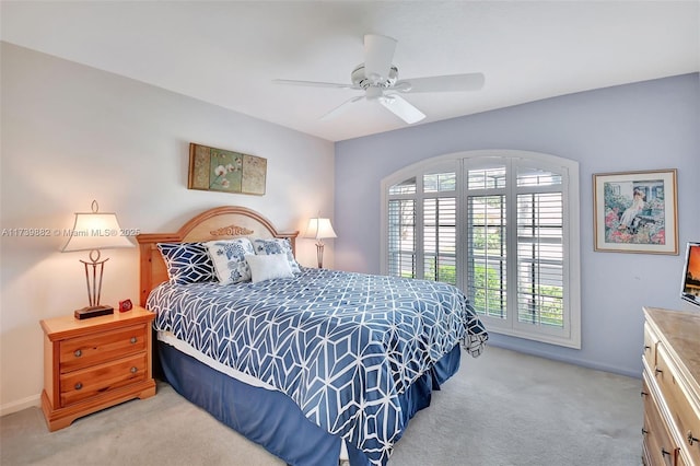 bedroom with ceiling fan and light colored carpet